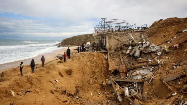 Palestinos inspeccionan los escombros de un edificio tras un ataque israelí contra un puerto pesquero en Deir el-Balah, en el centro de la Franja de Gaza, el 22 de marzo de 2025. (Eyad Baba/AFP vía Getty Images)