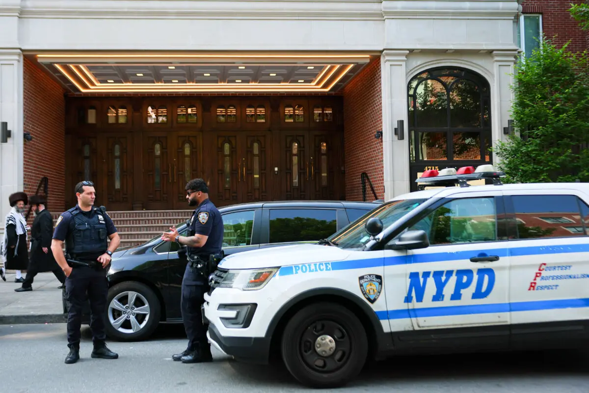 Miembros de la comunidad judía ortodoxa pasan junto a oficiales de la policía de Nueva York en el barrio de Borough Park, en la ciudad de Nueva York, el 2 de junio de 2025. (Michael M. Santiago/Getty Images).