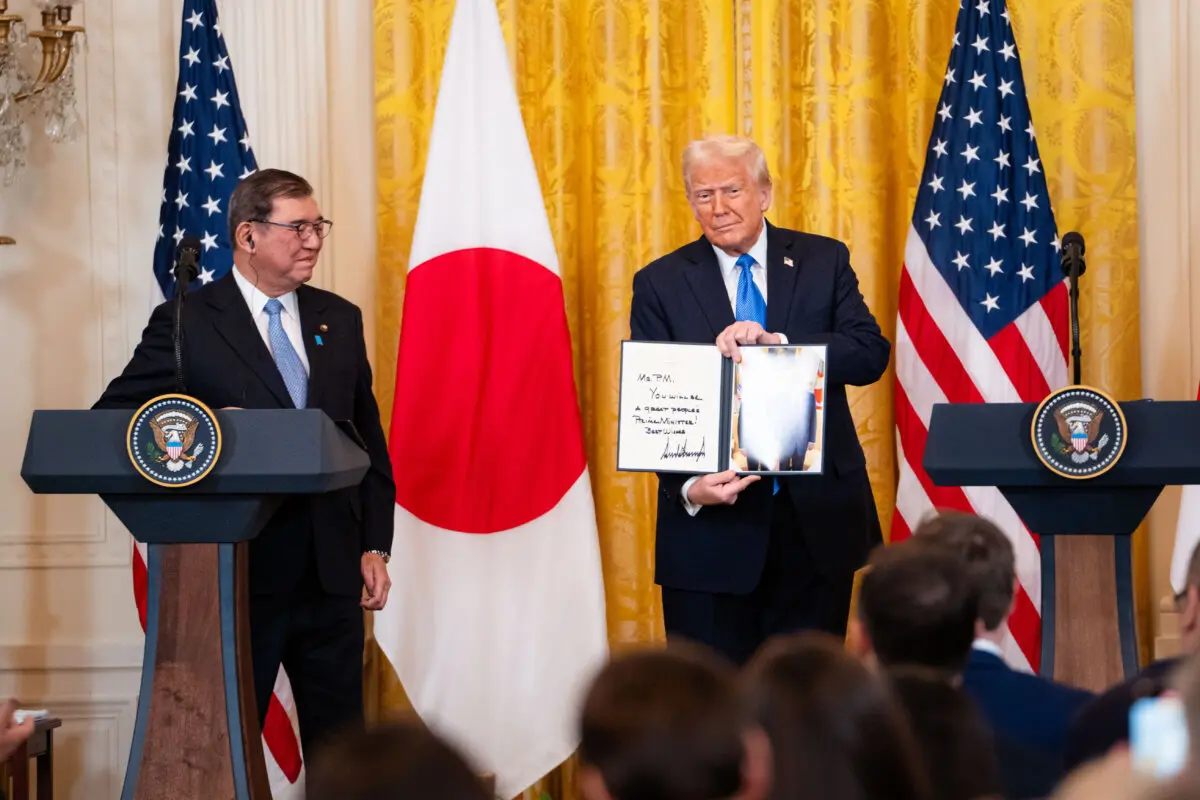 El presidente Trump sostiene un regalo para el primer ministro japonés, Shigeru Ishiba, durante una rueda de prensa en el Salón Este de la Casa Blanca el 7 de febrero de 2025. (Madalina Vasiliu/The Epoch Times)