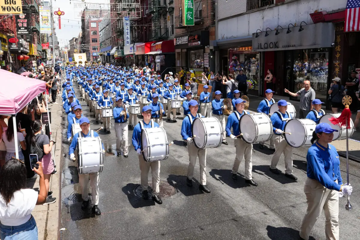 Practicantes de Falun Gong marchan durante un desfile en el que se pide el fin de los 26 años de persecución del Partido Comunista Chino contra la práctica espiritual, en la ciudad de Nueva York, el 20 de julio de 2025. (Larry Dye/The Epoch Times)