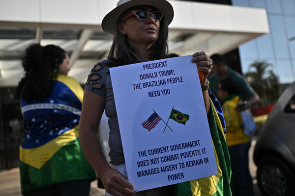 Una simpatizante del expresidente de Brasil, Jair Bolsonaro, sostiene un cartel este sábado, frente al hospital DF Star en Brasilia (Brasil). Bolsonaro, que cumple prisión domiciliaria mientras es juzgado por golpismo, abandonó la residencia en la que está recluido hace dos semanas para someterse a una serie de exámenes médicos en un hospital, autorizado por la Corte Suprema. (EFE/ Andre Borges)