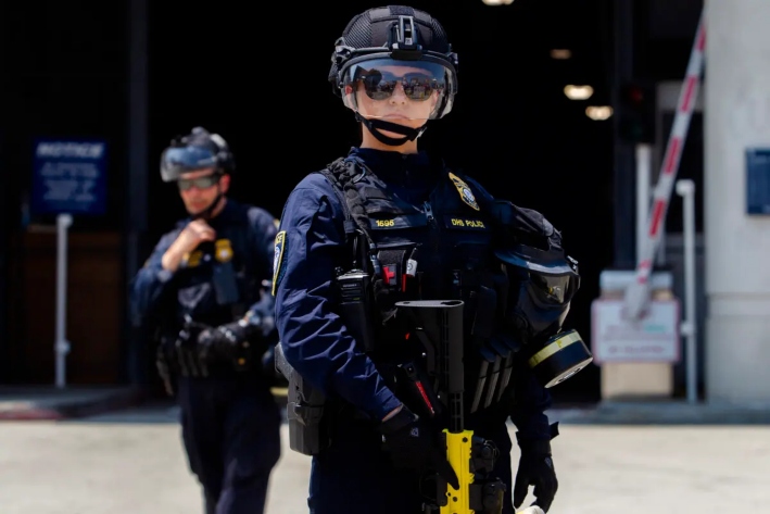 Agentes del Departamento de Seguridad Nacional (DHS) montan guardia frente al edificio federal Edward R. Roybal y el centro de detención mientras manifestantes protestan en Los Ángeles, el 2 de agosto de 2025. (Apu Gomes/Getty Images)