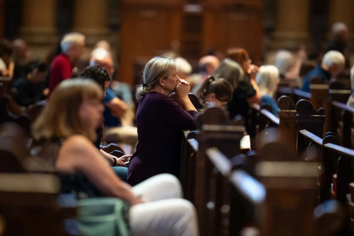 La gente reza en la catedral de Saint Paul, tras el tiroteo en la escuela católica Annunciation, en Saint Paul, Minnesota, el 28 de agosto de 2025. (Madalina Kilroy/The Epoch Times)