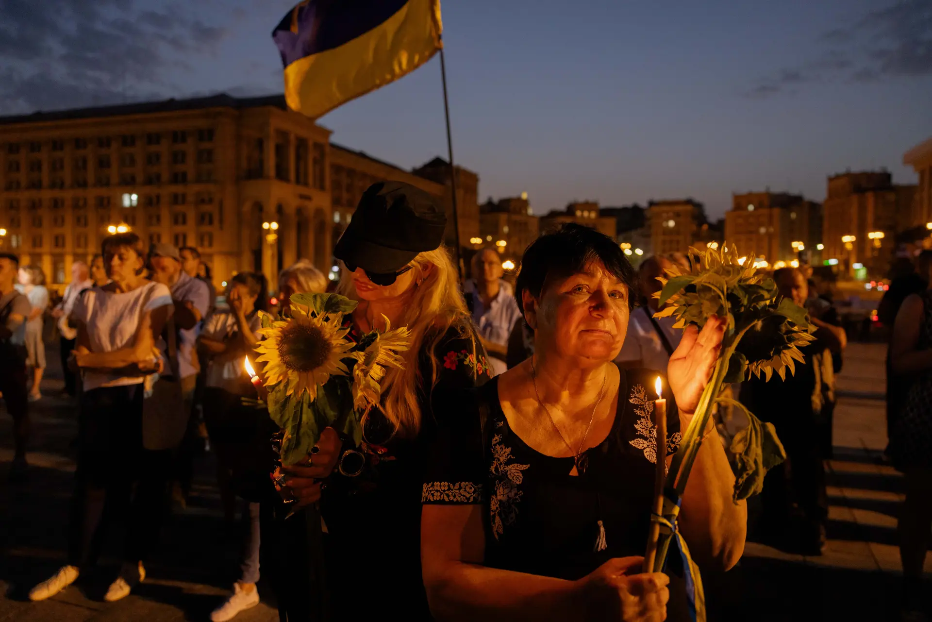 Una mujer sostiene una vela y un girasol mientras asiste a una ceremonia en honor al fallecido expresidente del parlamento ucraniano Andriy Parubiy en la Plaza de la Independencia de Kiev, el 1 de septiembre de 2025, durante la invasión rusa de Ucrania. Parubiy, figura destacada de los movimientos de protesta proeuropeos del país de 2004 y 2014, fue asesinado a tiros el 30 de agosto en la ciudad de Lviv, en el oeste de Ucrania. (Tetiana Dzhafarova/AFP vía Getty Images)