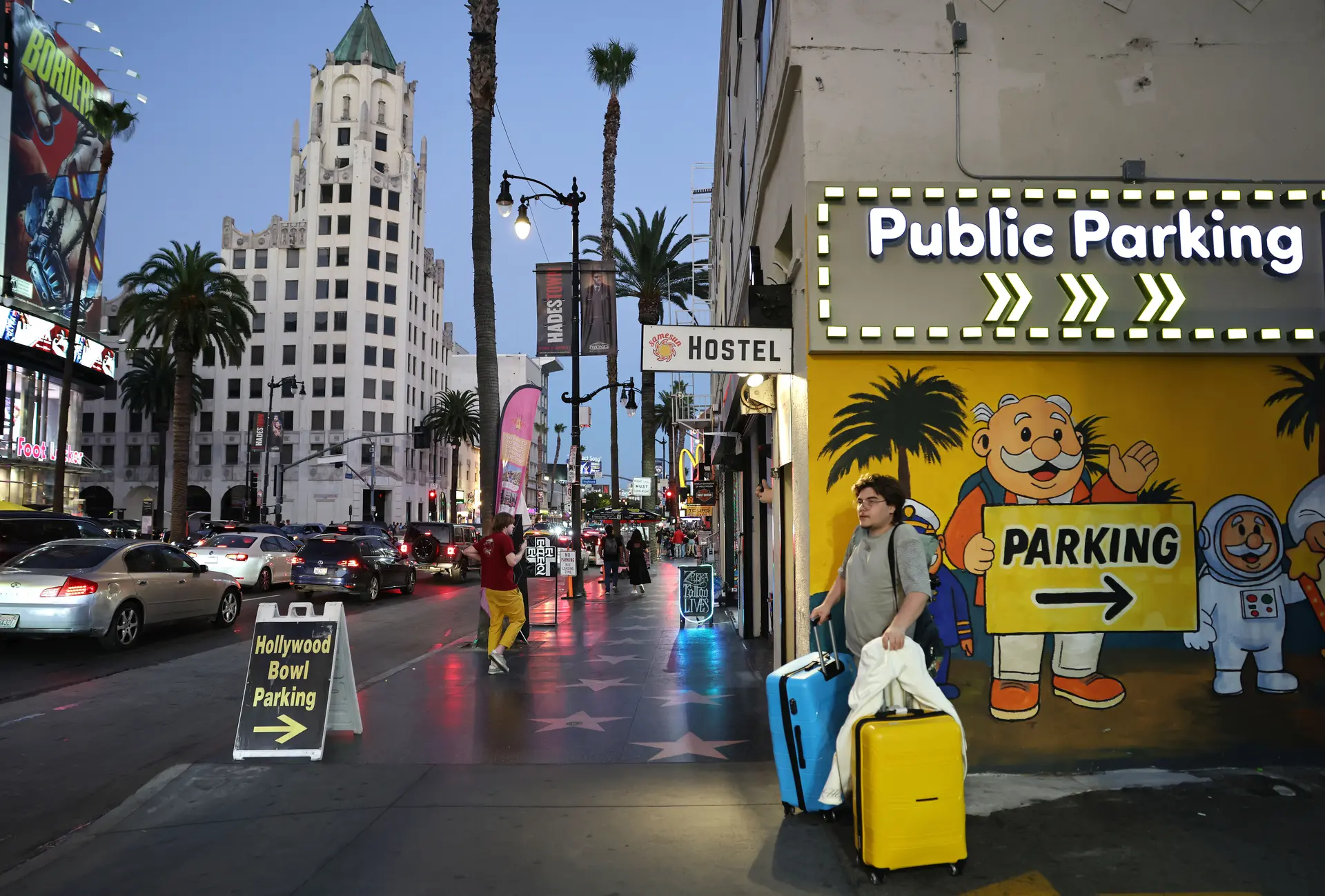 Un visitante camina con su equipaje por Hollywood Boulevard, en Los Ángeles, el 1 de octubre de 2025. (Mario Tama/Getty Images)
