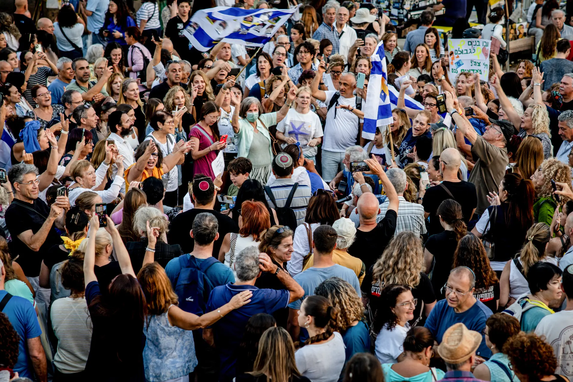 <em>La gente se reúne y ondea banderas en reacción a la noticia del acuerdo de paz entre Israel y Hamás, en un lugar que se conoce como la Plaza de los Rehenes en Tel Aviv, Israel, el 9 de octubre de 2025. (Chris McGrath/Getty Images)</em>