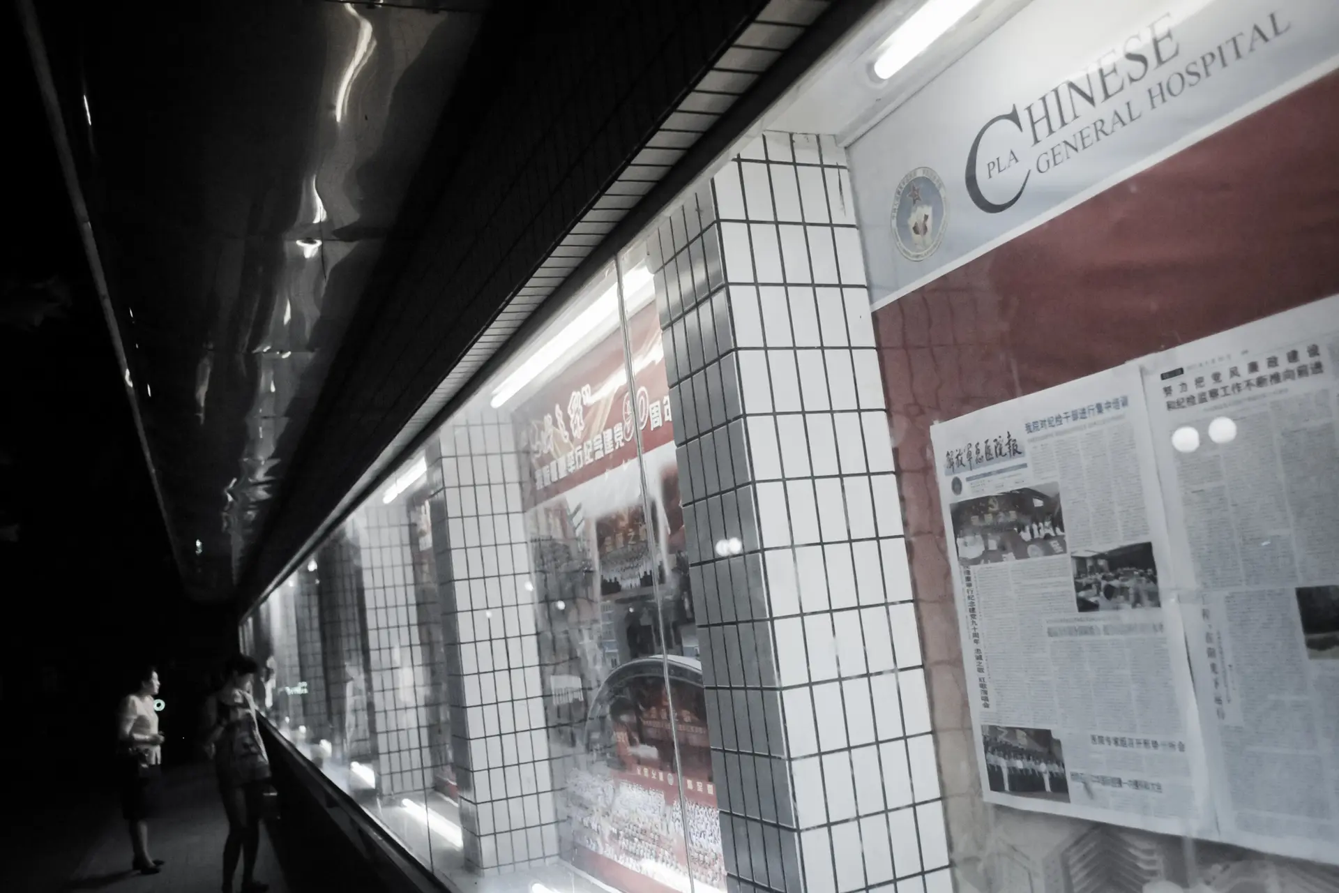 La gente lee artículos y ve fotos en un tablón de anuncios en el recinto del Hospital 301, donde los principales líderes chinos suelen recibir atención médica, en Beijing, el 6 de julio de 2011. (Goh Chai Hin/AFP a través de Getty Images).