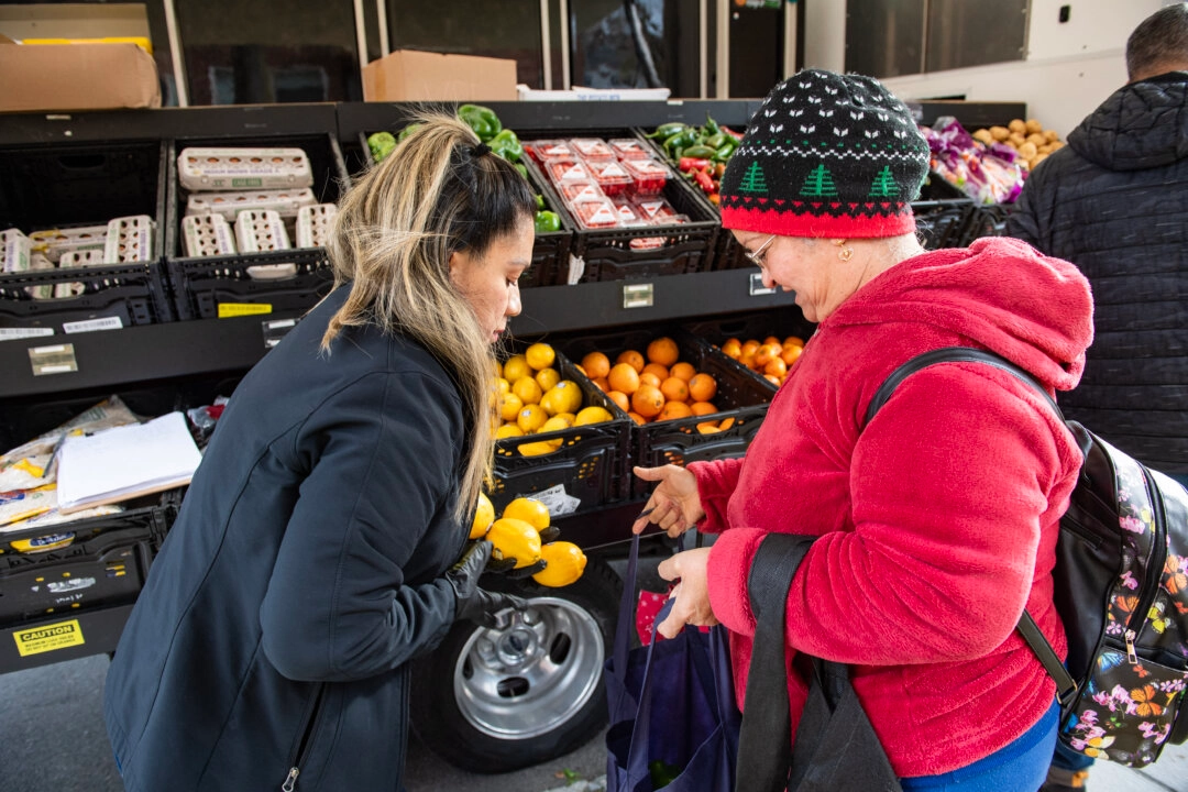 <em>Personas reciben comida en un evento de comida gratuita para beneficiarios de cupones de alimentos en Chelsea, Massachusetts, el 13 de noviembre de 2025. (Joseph Prezioso/AFP vía Getty Images)</em>